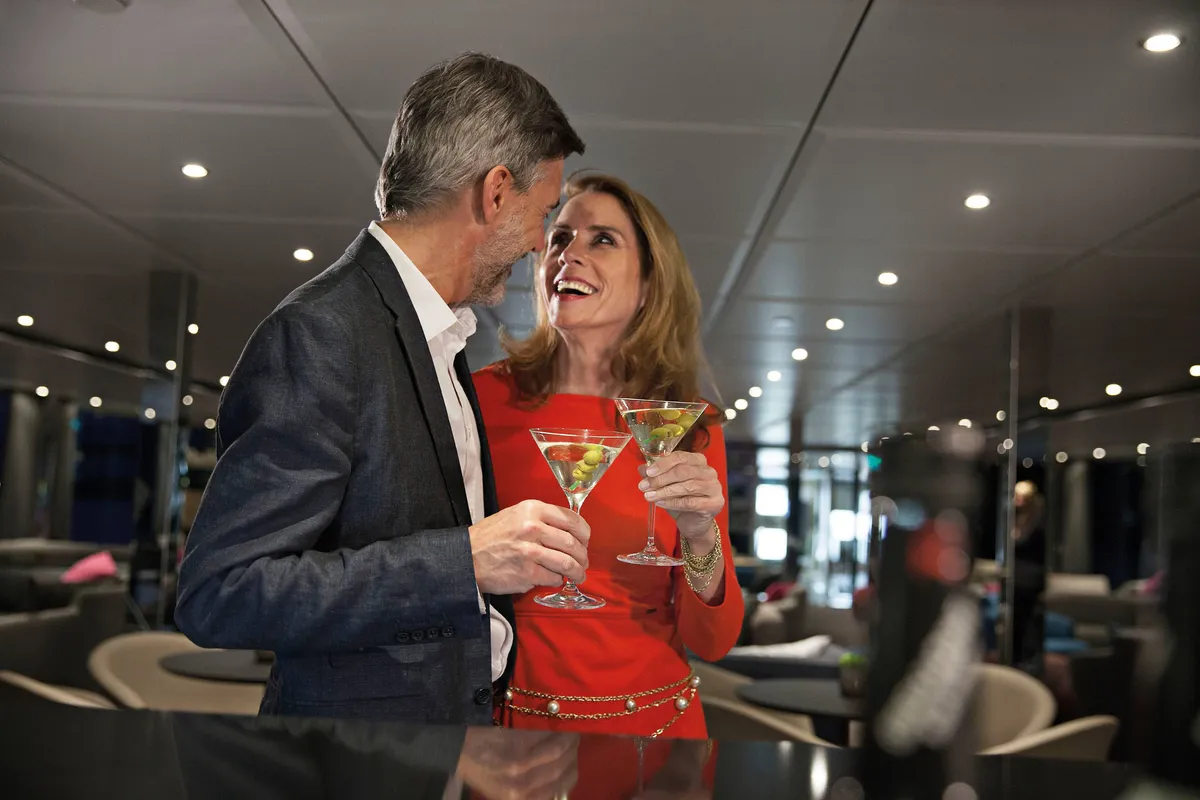 Couple enjoying cocktails at the ship's lounge