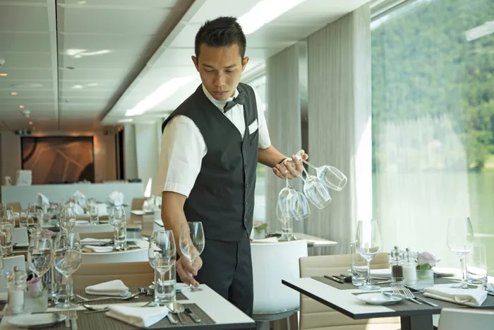 Staff member serving guests on deck